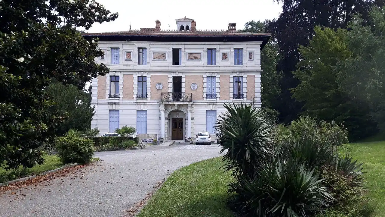 Impozantna bela vila simetričnog dizajna, okružena zelenilom i prilaznom stazom – dvorac renoviran od strane Dominium Home.